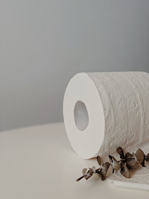 White Toilet Paper Roll on White Table