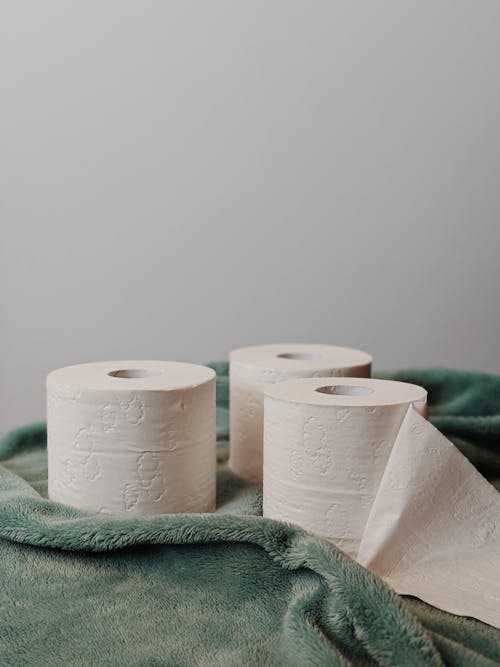 Free Toilet Paper Rolls on Green Towel Stock Photo