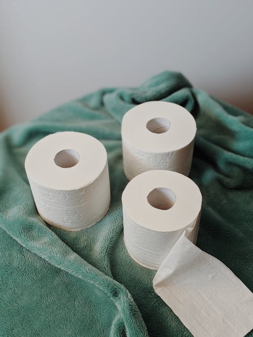 Free White Toilet Paper Roll on Green Towel Stock Photo
