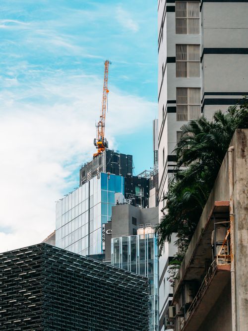 Free A cityscape featuring a crane and skyscraper under construction, with modern architecture. Stock Photo