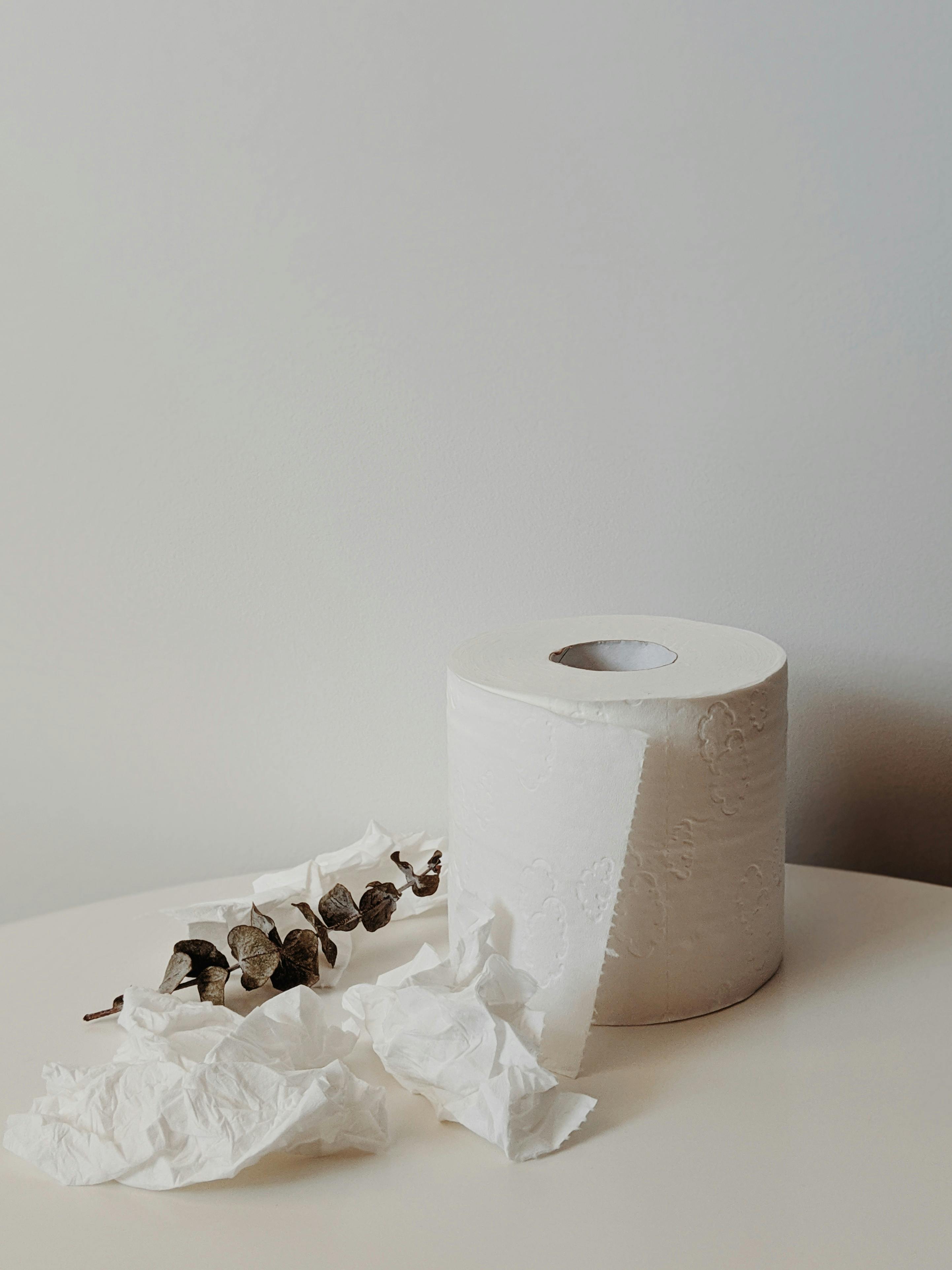 White Toilet Paper Roll on White Table