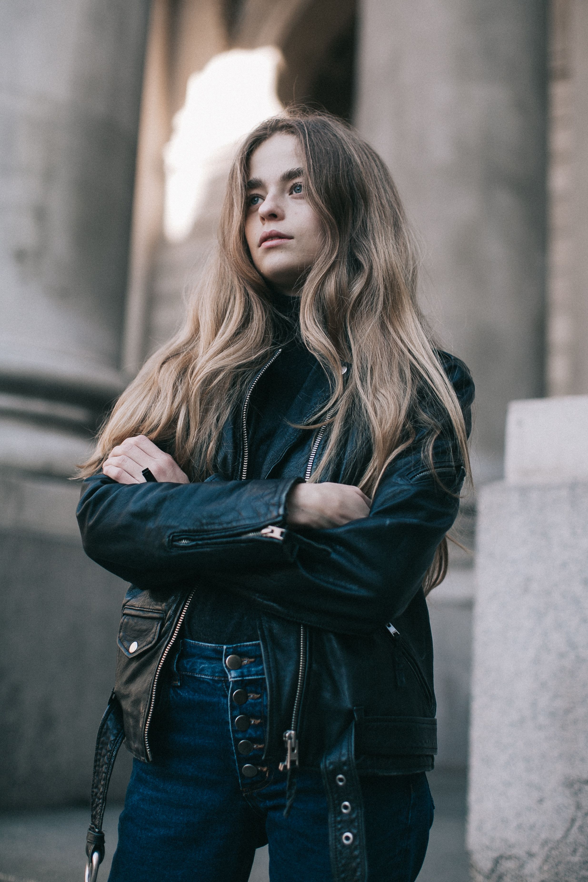 Woman in Black Leather Jacket Standing Outside Building · Free Stock Photo
