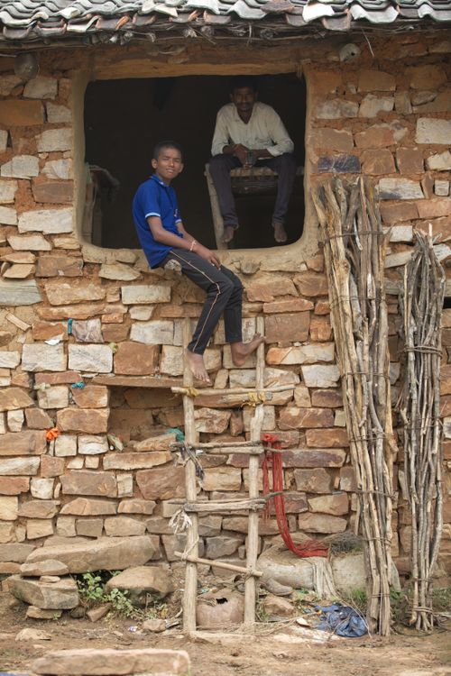 Free Traditional Indian stone house with ladder and villagers in Naimisharanya, UP. Stock Photo