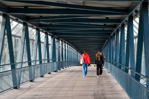 Free People walking on a modern pedestrian bridge in Jyväskylä, Finland. Stock Photo