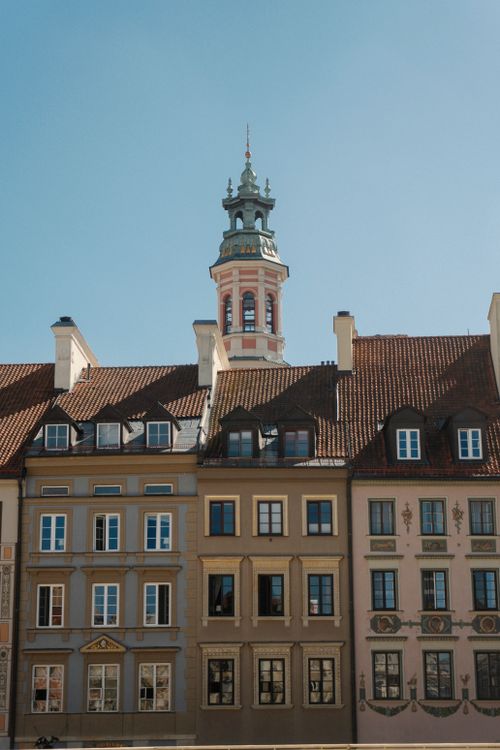 Free Charming historic Warsaw townhouses with spires under a clear blue sky. Stock Photo