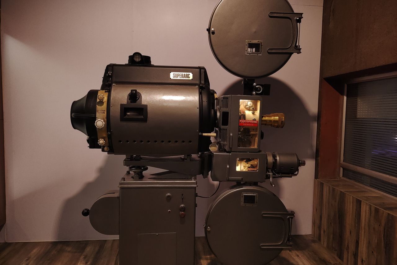 Old-fashioned Superarc film projector displayed indoors, evoking cinematic history.