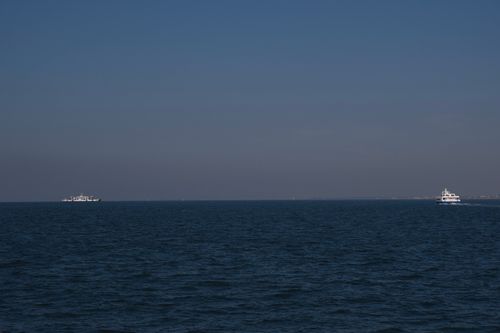 Free Two ferries traverse the calm Aegean Sea under a clear blue sky near İzmir, Turkey. Stock Photo
