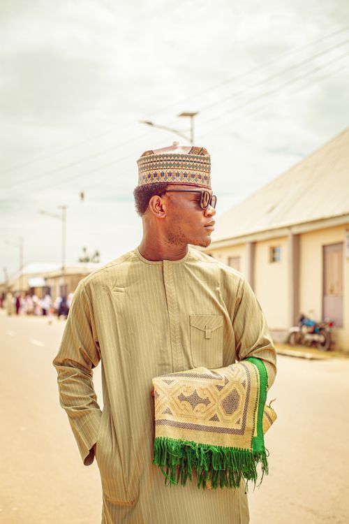 Free A man in traditional attire stands on a street, embracing cultural heritage. Stock Photo