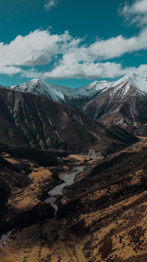 Free Stunning aerial view of snow-capped Southern Alps in New Zealand under a clear blue sky. Stock Photo