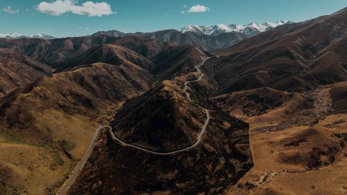Free Stunning aerial view of winding road through mountains near Arthur's Pass, New Zealand. Stock Photo