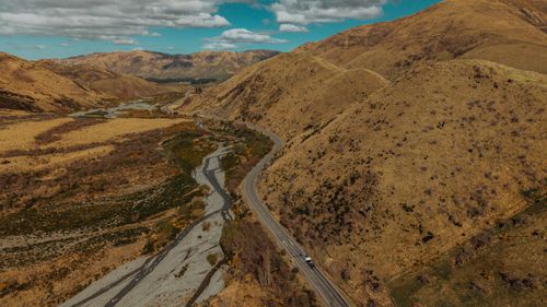 Free A winding road through Canterbury's dry hills and valleys on a sunny day, New Zealand. Stock Photo