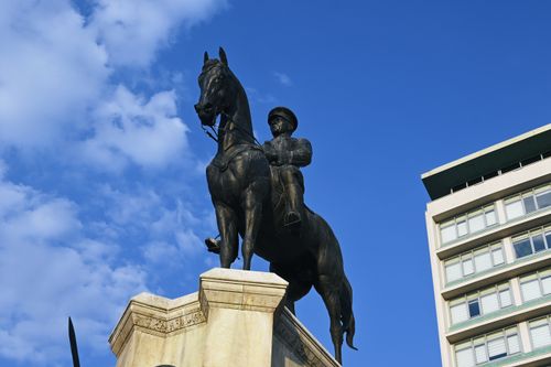 Free Impressive equestrian statue in Ankara, Türkiye, set against a bright blue sky and modern architecture. Stock Photo