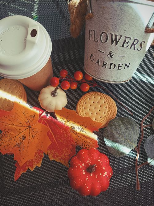 Free Cozy autumn scene with coffee, biscuits, pumpkins, and fall leaves. Stock Photo