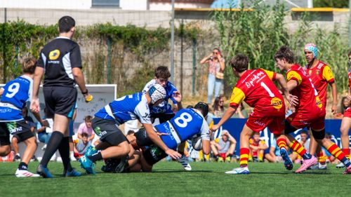Free Dynamic youth rugby match showcasing intense competition and teamwork outdoors. Stock Photo