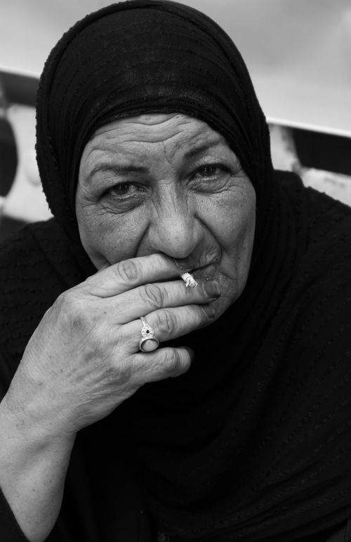 Free Powerful black-and-white portrait of a senior woman wearing a hijab, deep in thought. Stock Photo