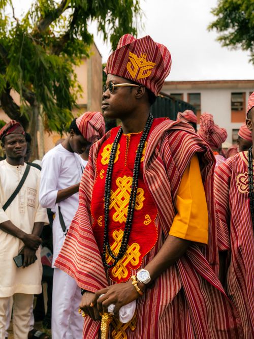 Free Men in vibrant Yoruba attire at a traditional Nigerian ceremony, showcasing rich cultural heritage. Stock Photo