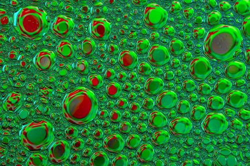 Free Explore colorful soap bubbles with vibrant red and green hues creating an abstract organic design. Stock Photo