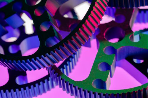 Free Vivid macro shot of colorful interlocking metal gears, highlighting industrial precision and engineering concepts. Stock Photo