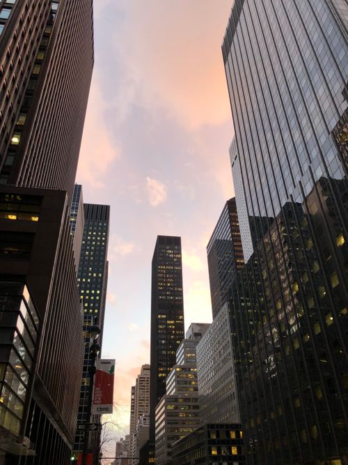 Free A stunning view of New York City's skyscrapers against a vibrant sunset sky. Stock Photo