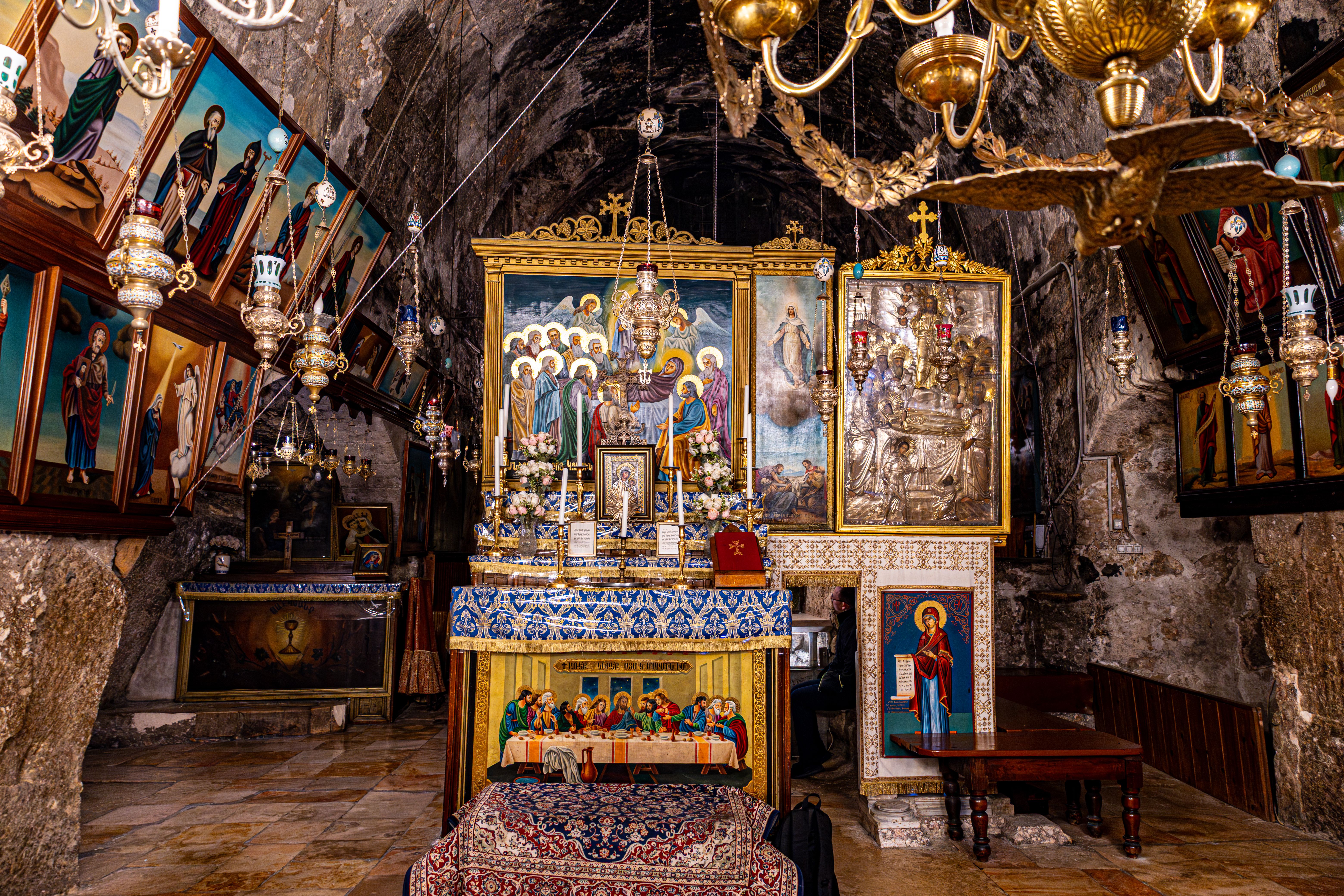 Intricate altar with religious icons in a Jerusalem church interior, showcasing traditional Christian art and decor.