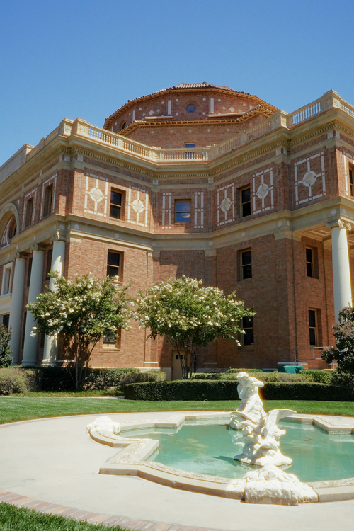Free Stunning view of a historic building in Atascadero with a decorative fountain in the foreground. Stock Photo