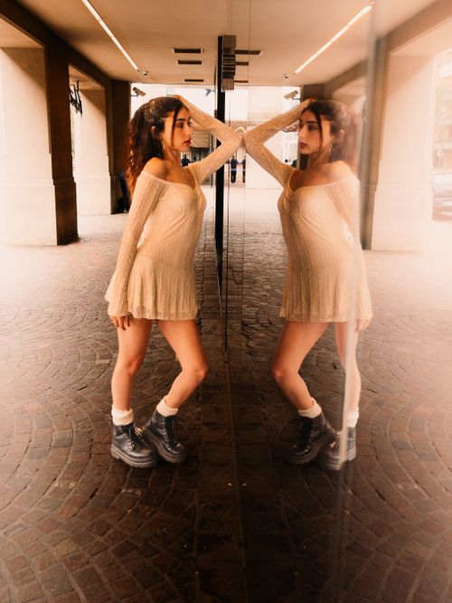 Free A fashion model explores self-reflection in the cityscape of Buenos Aires. Stock Photo