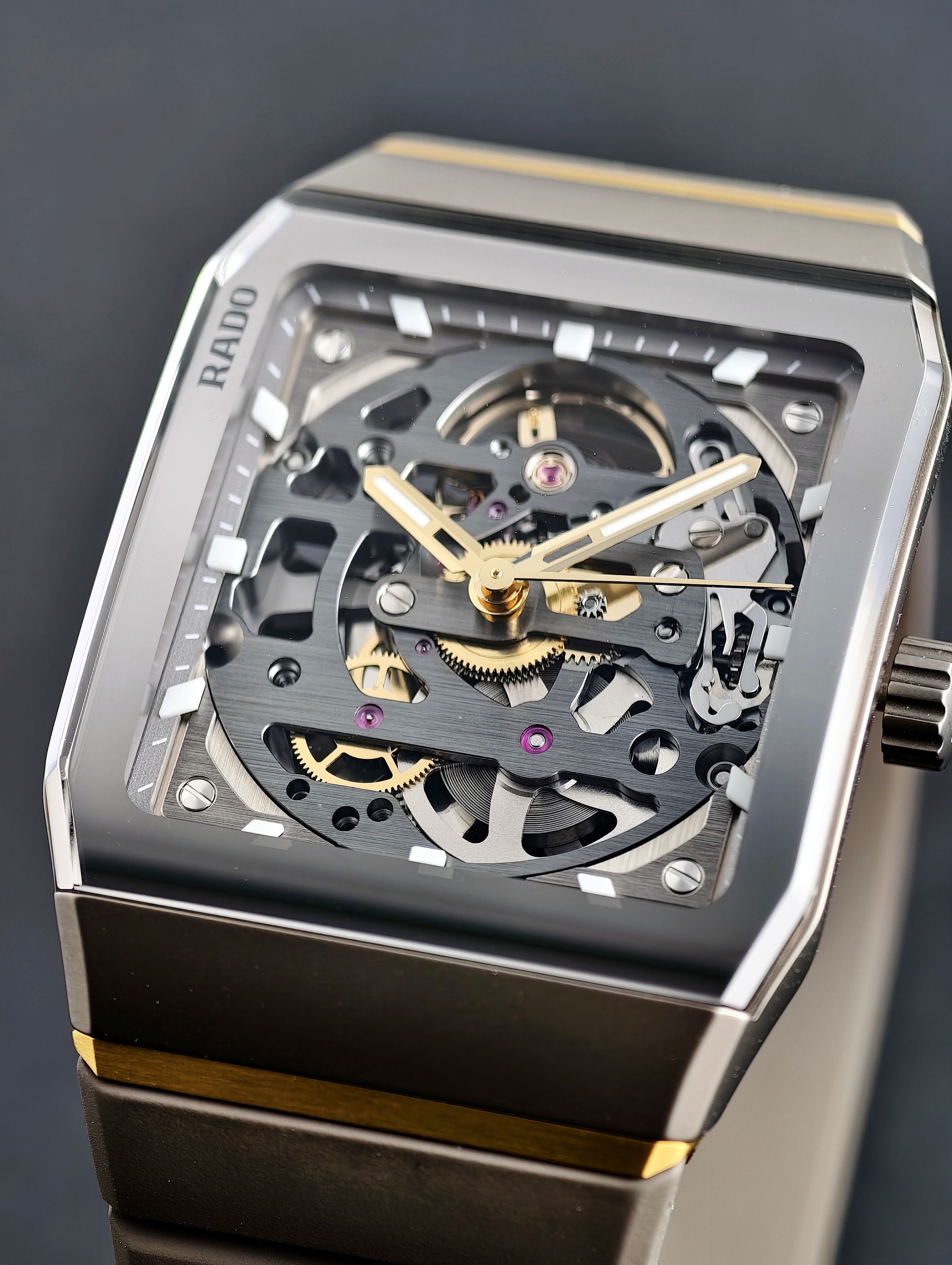 Close-up of a luxury skeleton watch showcasing its intricate internal mechanics and elegant design.