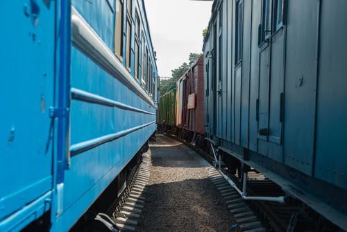 Free Two colorful train cars aligned on parallel tracks in daylight, captured outdoors. Stock Photo
