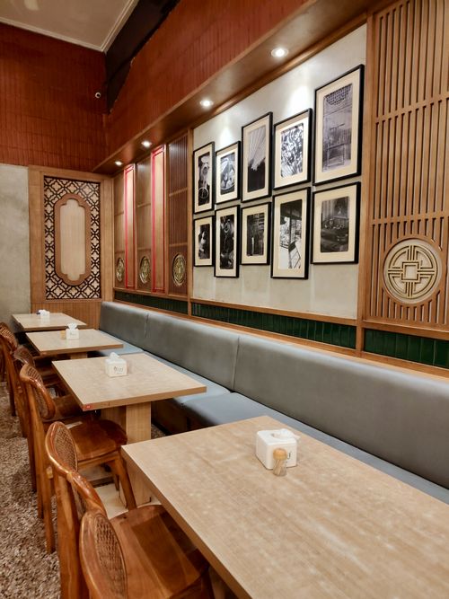 Free Warm and inviting seating area in an Indonesian restaurant with artistic wall decor. Stock Photo