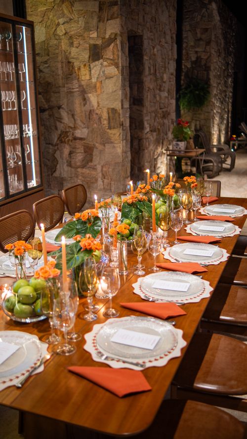Free Beautifully set dining table with orange flowers and candles, perfect for special occasions. Stock Photo
