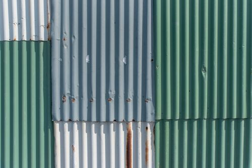 Free Close-up of weathered corrugated iron sheets showing rust and texture. Stock Photo