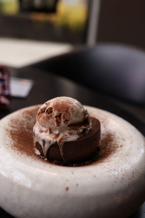 Free Indulge in a rich chocolate lava cake topped with creamy ice cream, perfect dessert delight. Stock Photo