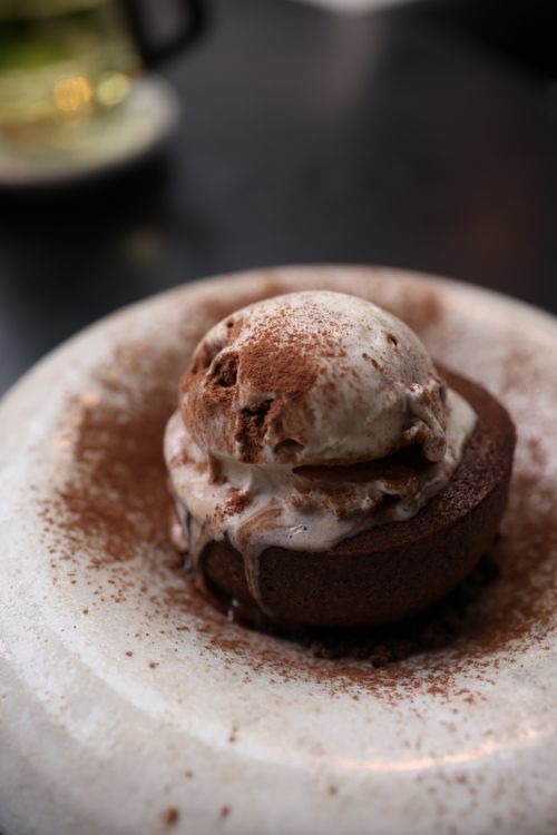 Free Delicious chocolate lava cake topped with melting vanilla ice cream, dusted with cocoa. Stock Photo