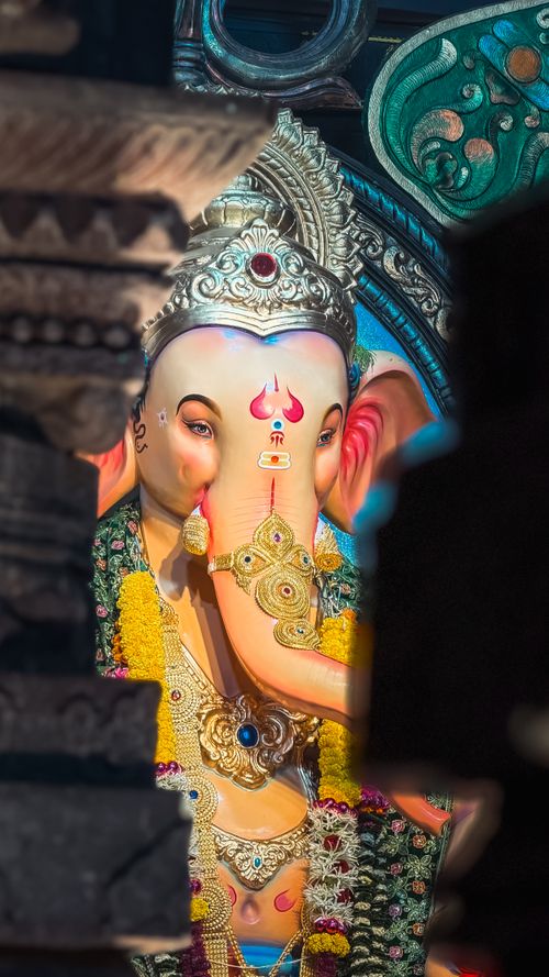 Free Close-up of a beautifully adorned Ganesha idol surrounded by festive elements, captured indoors. Stock Photo