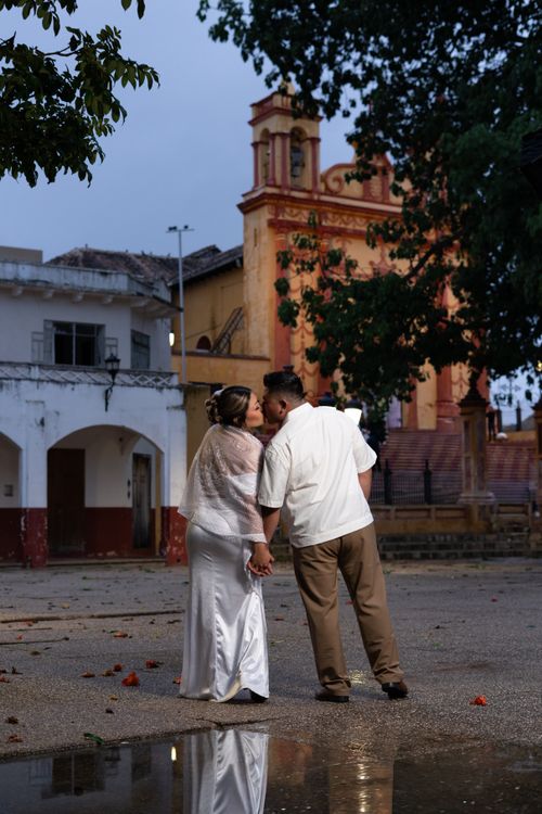 Free Couple enjoying a romantic moment before a historic church in Comitán de Domínguez, Mexico. Stock Photo
