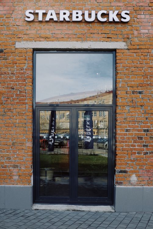 Entrance of modern cafe with signboard over door on street · Free Stock ...