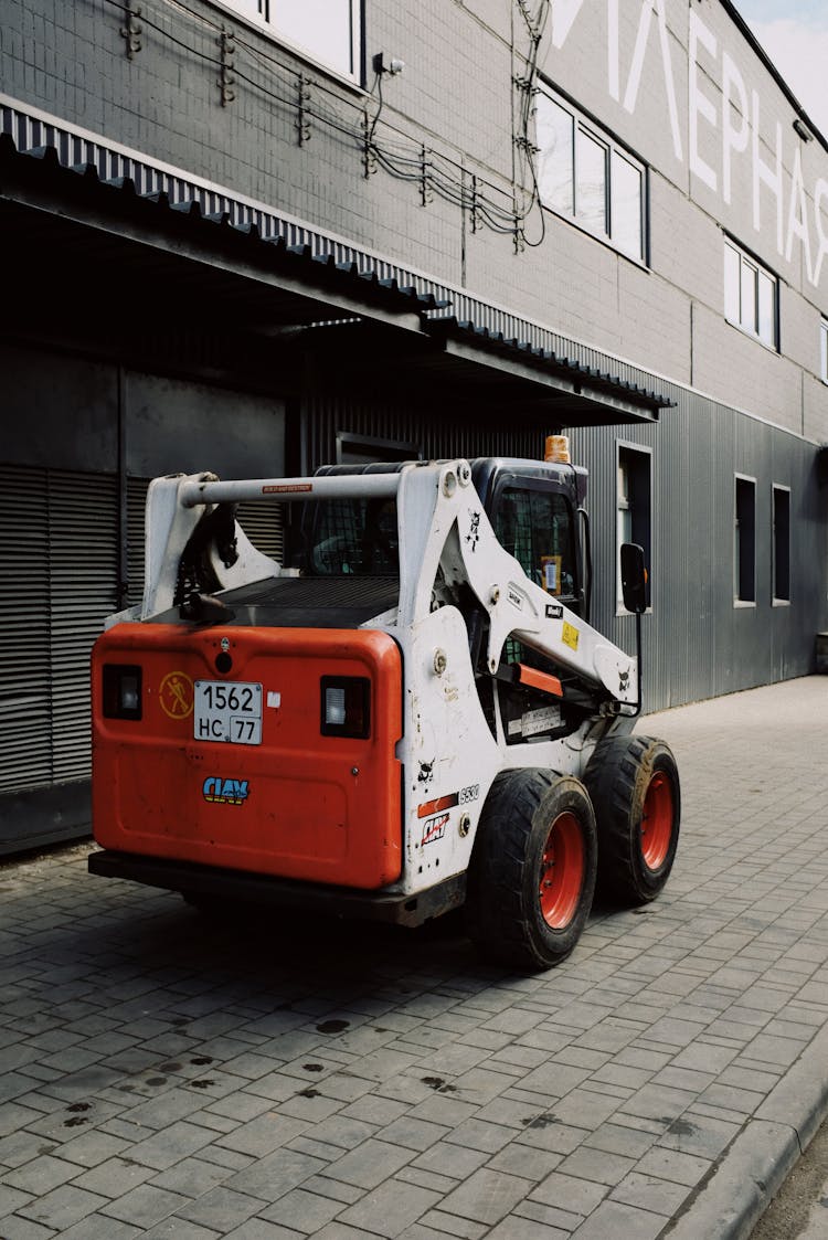 Modern Small Truck Parked Near Warehouse On Street In City