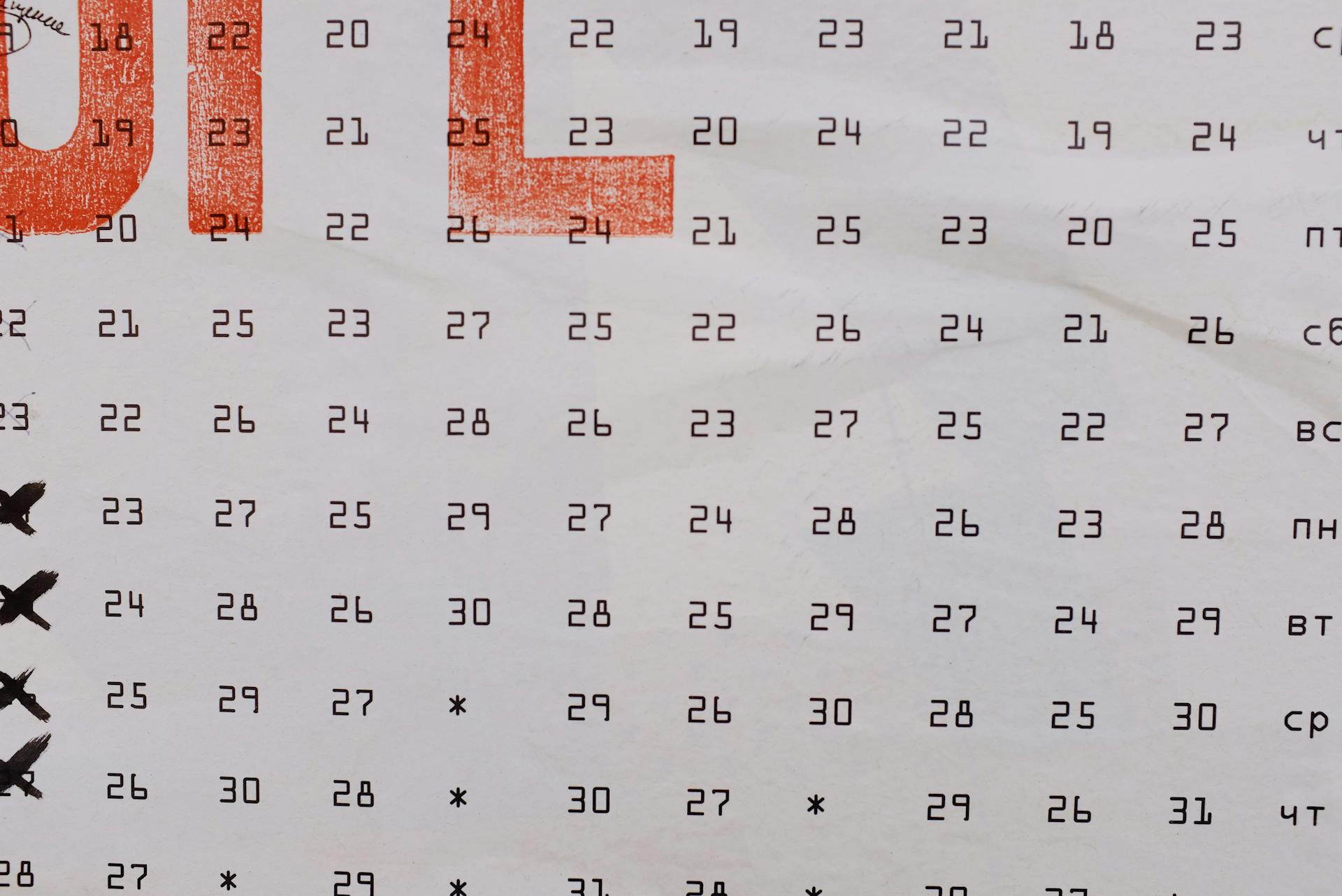 Artistic calendar display with highlighted red typography and marked dates.