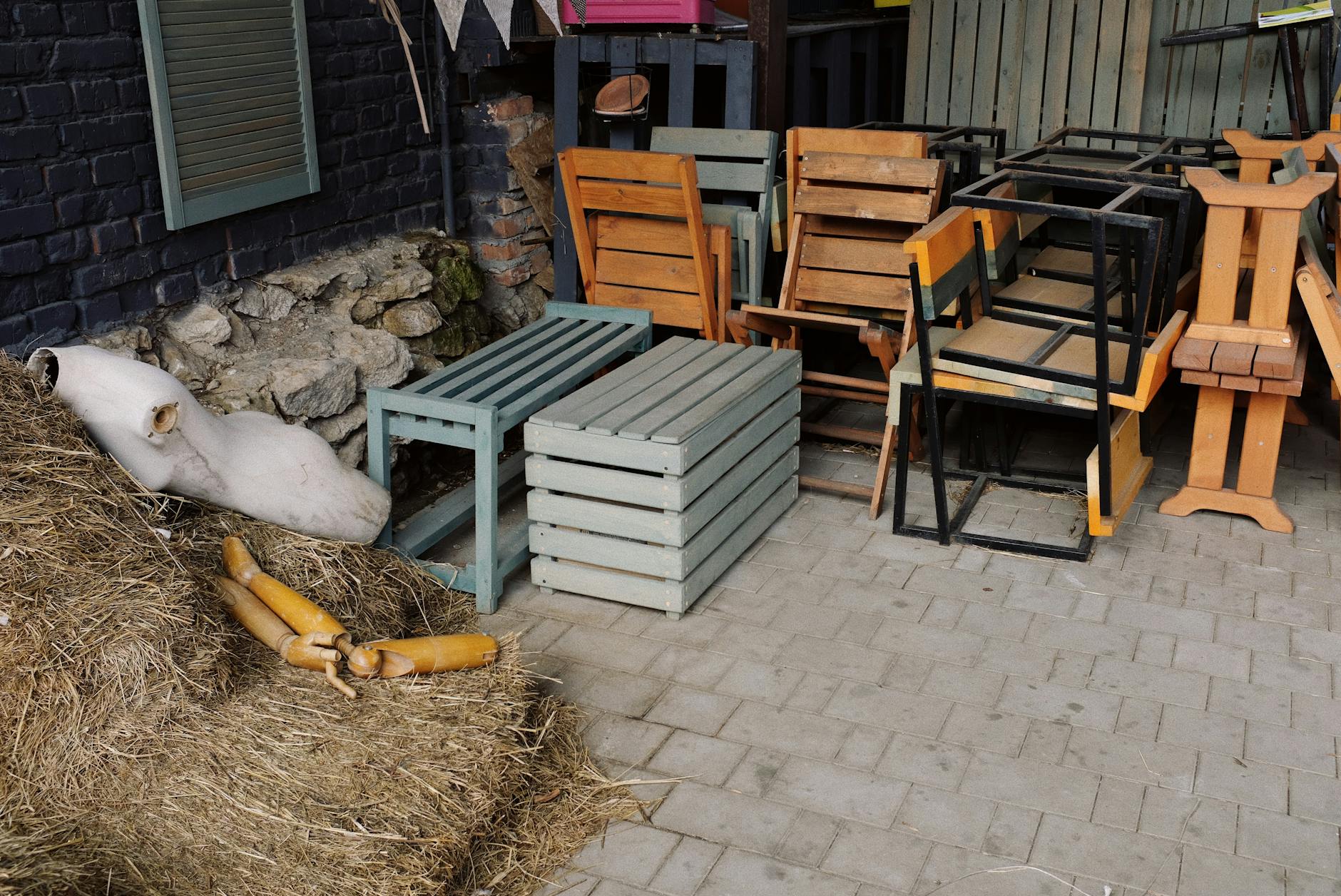 A patio with wooden chairs and tables