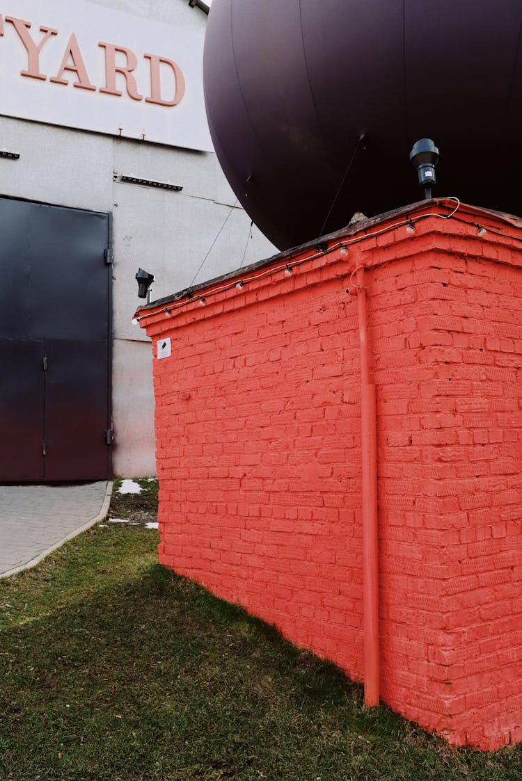 Red Modern Building With Big Ball On Roof