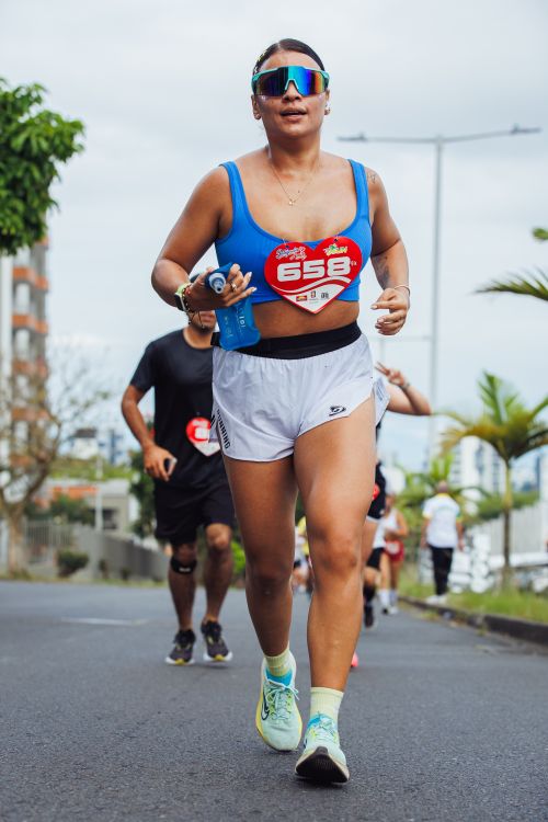 Free Determined female athlete running in a marathon outdoors. Focus on fitness and endurance. Stock Photo