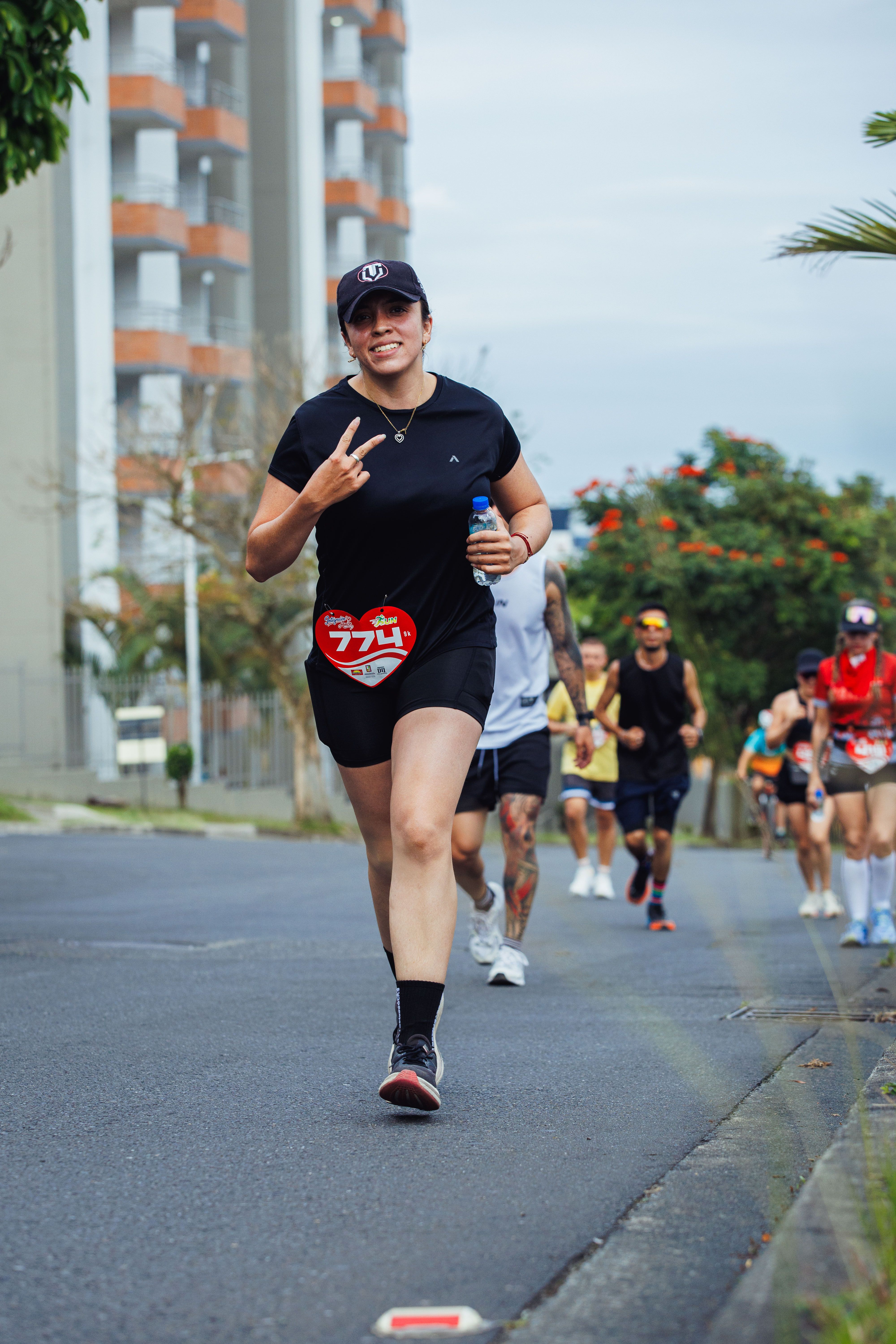 A group of runners energetically participate in an outdoor marathon event, showcasing fitness and camaraderie.