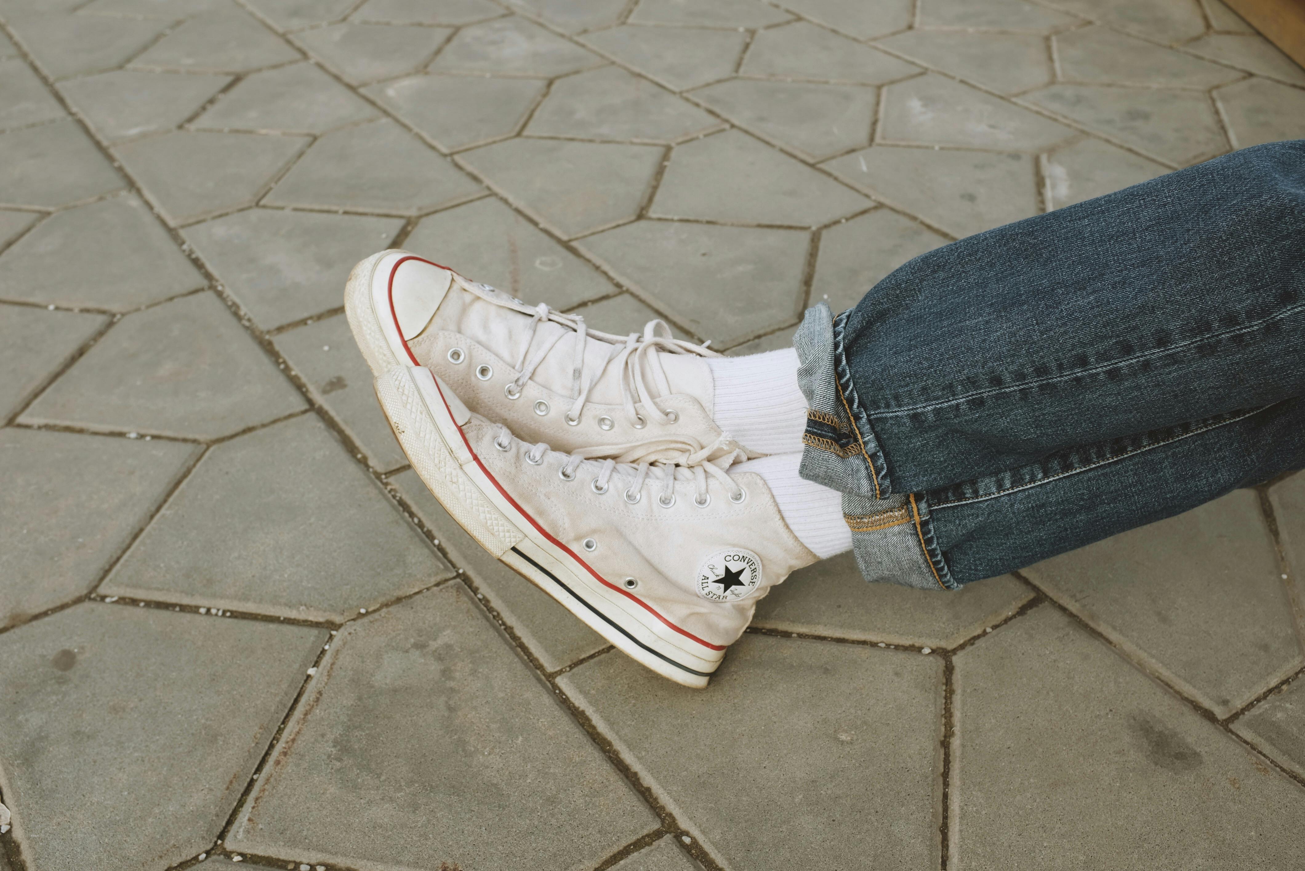 Person in Blue Denim Jeans and White Converse Sneakers · Free Stock Photo