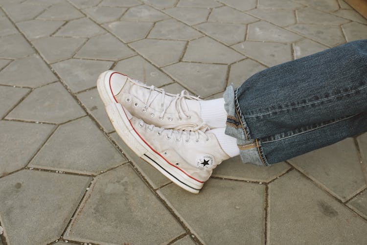 Person In Blue Denim Jeans And White Converse Sneakers