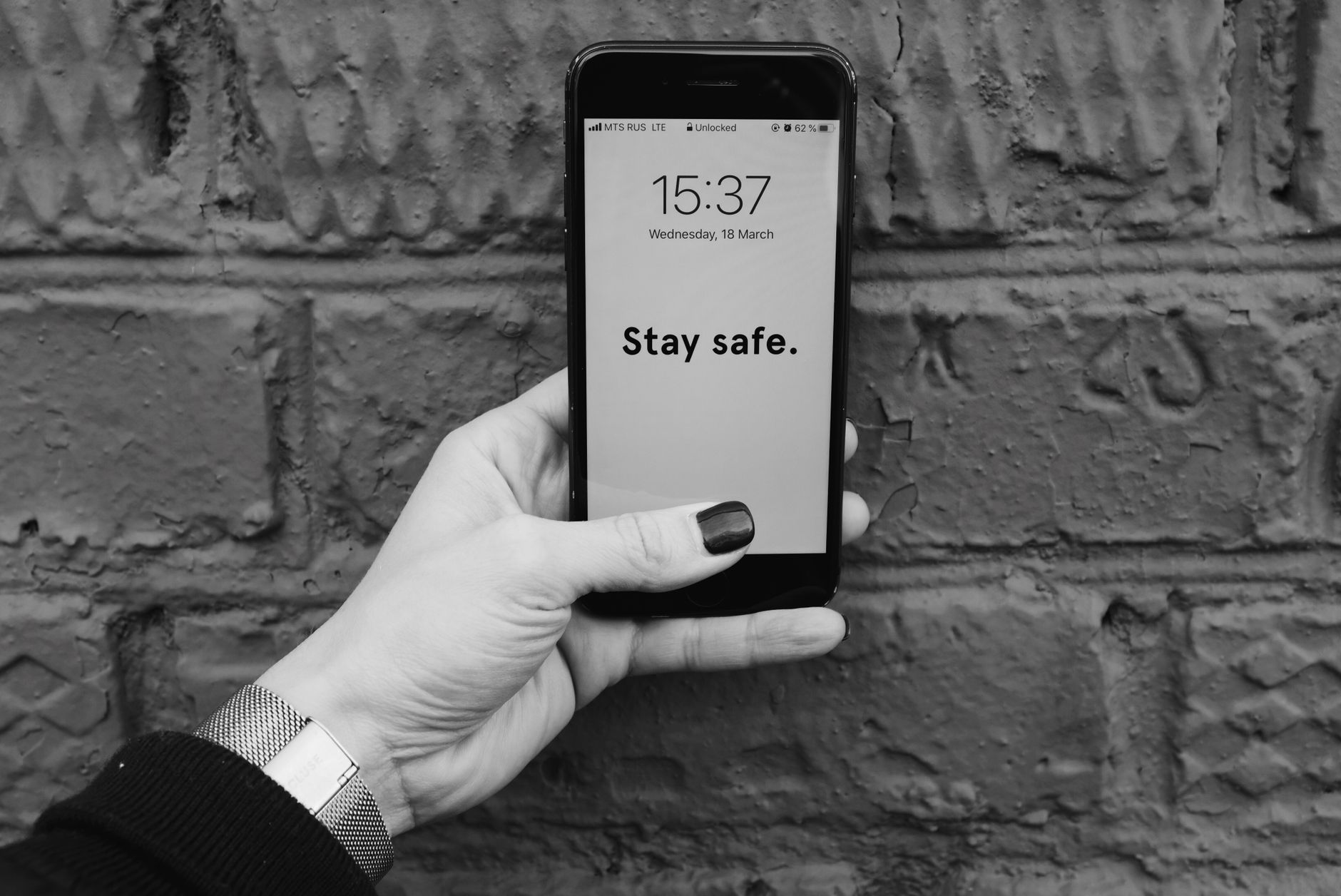 How to Tell If Your Phone Has Been Hacked: A Practical Guide image showing a person holding a smartphone with a caution message