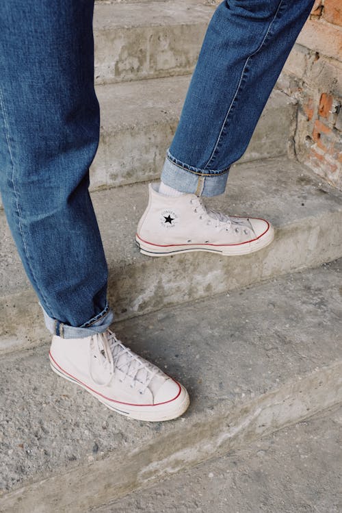 Person in Blue Denim Jeans and  White Sneakers