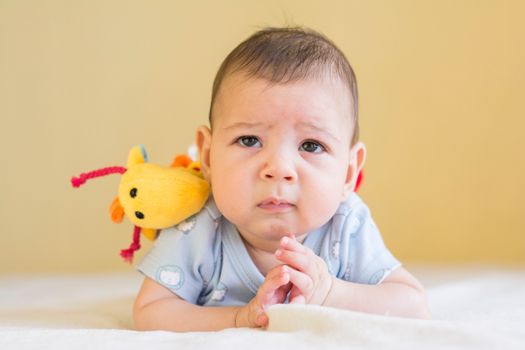 Baby in Blue Shirt Lying on Bed