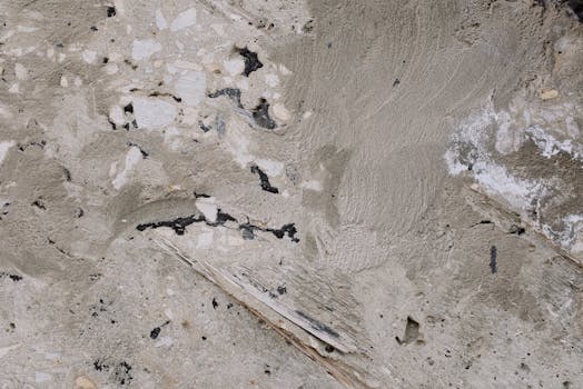 Close-up of a rough concrete surface showcasing texture and imperfections.
