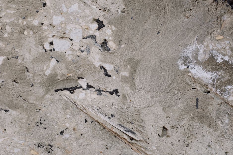 Close-up of a rough concrete surface showcasing texture and imperfections.