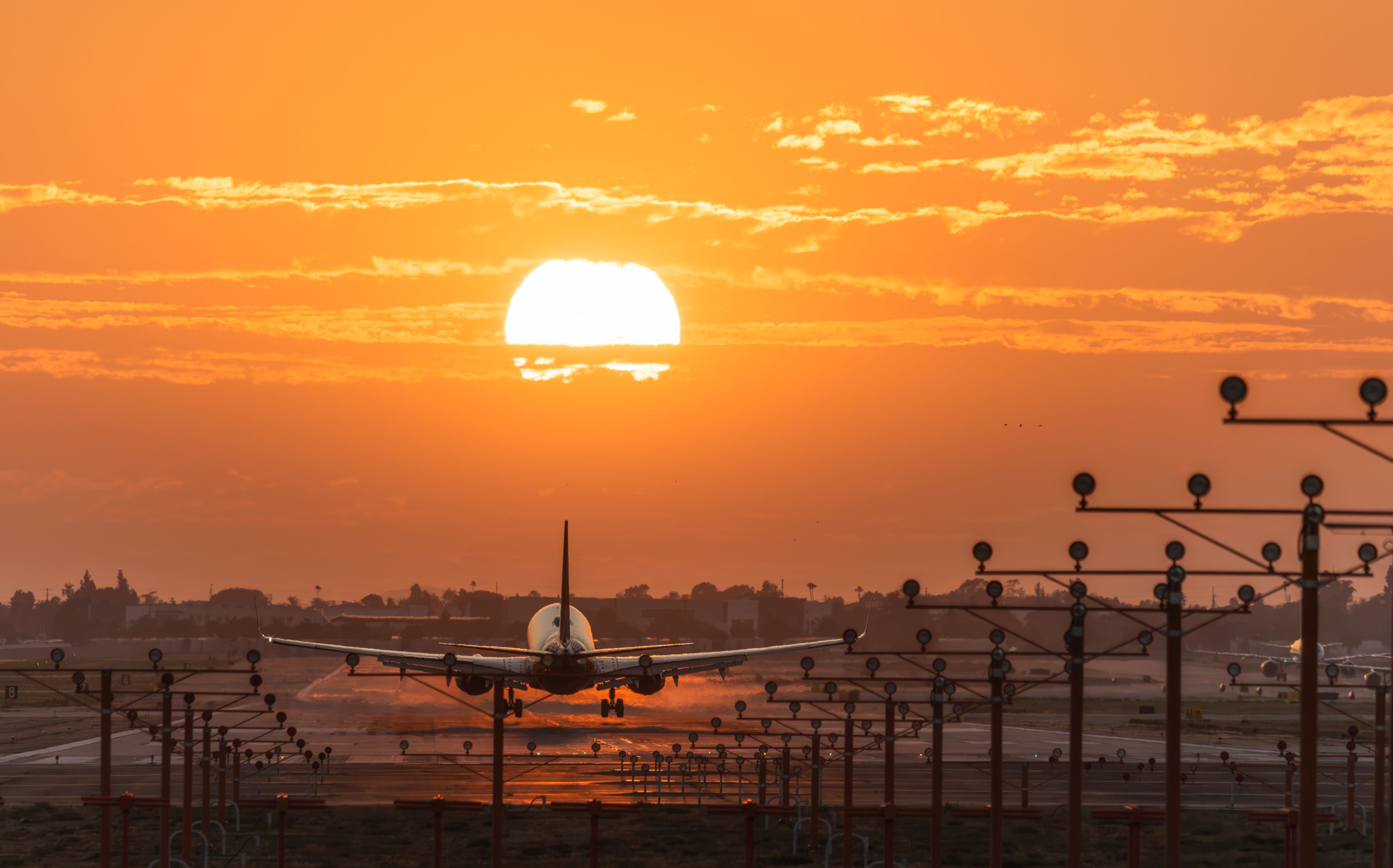 Ontario: A plane landing at Ontario Airport at sunset